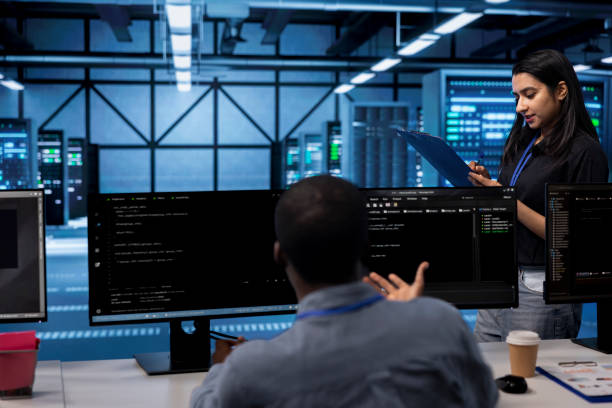 istock Engineer in server farm checking recovery plan, monitoring data center 2164504352