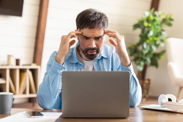 istock Frustrated Man With Beard Facing Laptop Issues in Home Office 2164504768