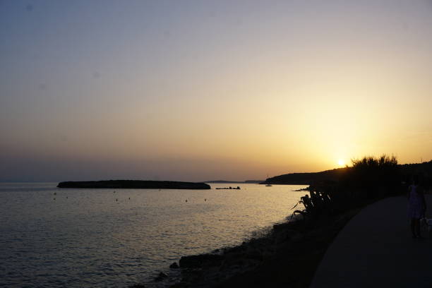 Mediterranean coast at sunset agains golden colores light
