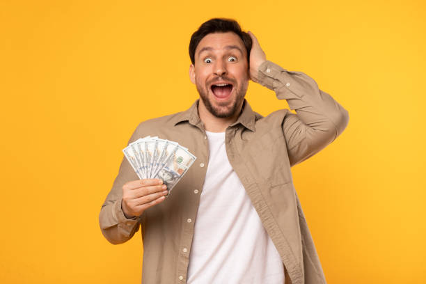istock Man Holding Money and Making a Funny Face 2164506556