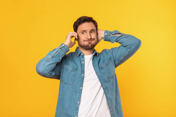 istock Puzzled Man in Blue Shirt Talking on Cell Phone 2164506578