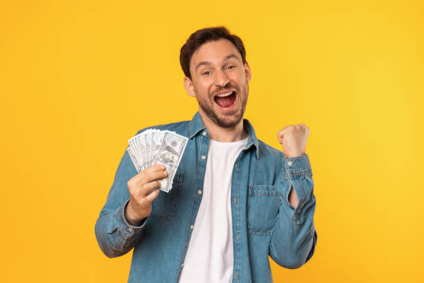 istock Man Holding a Bunch of Money and Gesturing 2164506584
