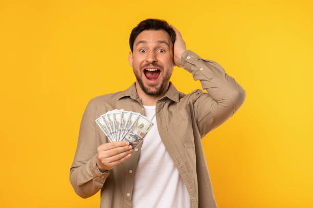 istock Man Holding Money and Making a Funny Face 2164506605