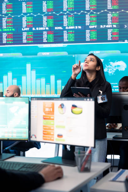 istock Team of forecast affiliates examining annual infographics on a big data screen 2164507882