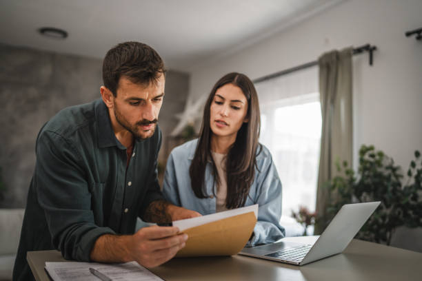 istock couple boyfriend and girlfriend open together letter from envelope 2164510604