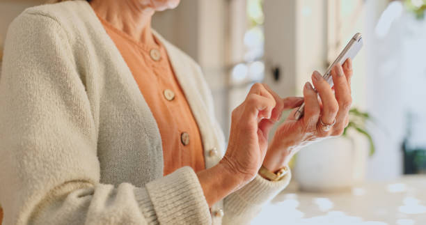 istock Home, hand and senior woman with phone for network, communication and scroll on technology. House, internet and elderly person with smartphone for digital media, information and online news website 2164514773