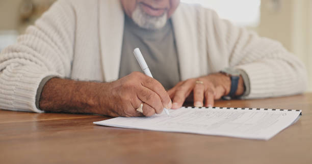 istock Home, writing and old man with documents, hands and folder for retirement plan, signature and form. Closeup, apartment and life insurance paperwork, legal agreement and pensioner with application 2164514824
