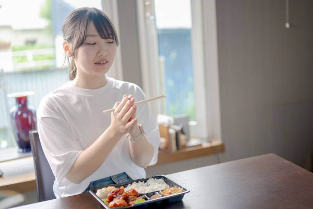 istock Lunch box and woman 2164516259