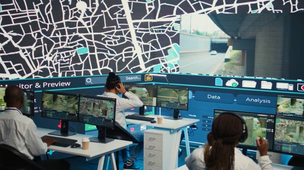 istock Diverse employees operators tracking delivery cars on satellite navigation 2164516275
