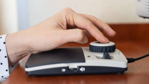 istock A woman uses a special magnification device for the visually impaired. 2164522977
