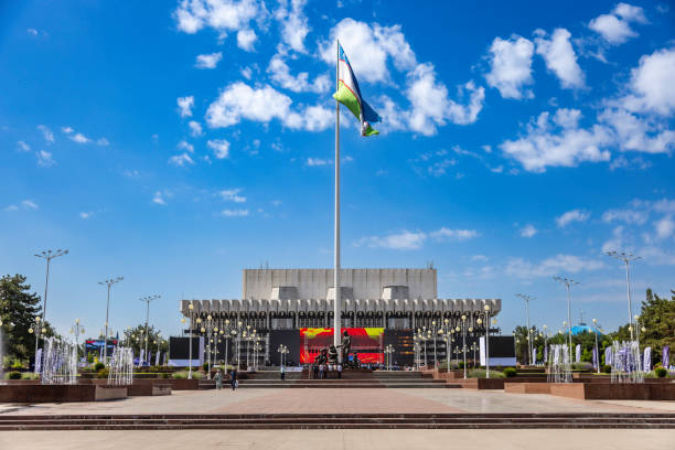 Tashkent, Uzbekistan. May 24th, 2025.Visitors and cleaning staff at the Friendship of the Nations Square in central Tashkent with the sculpture dedicated to Shaahmed Shamakhmudov and his wife who took care of 15 orphans during the Great Patriotic War.