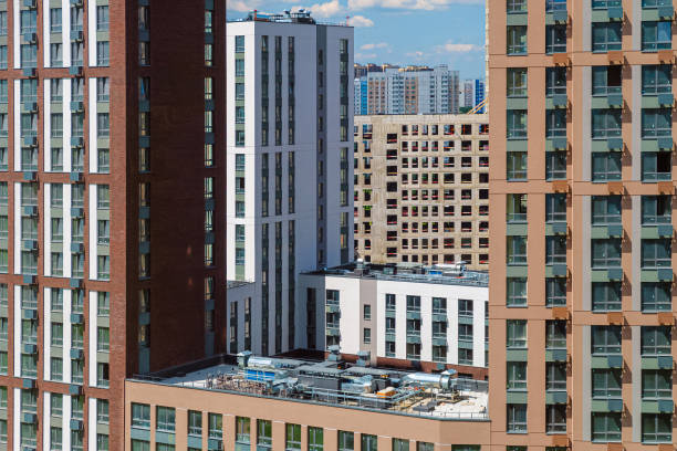 istock Facades one after another with windows. Simple high-rise residential typical buildings. 2164534613