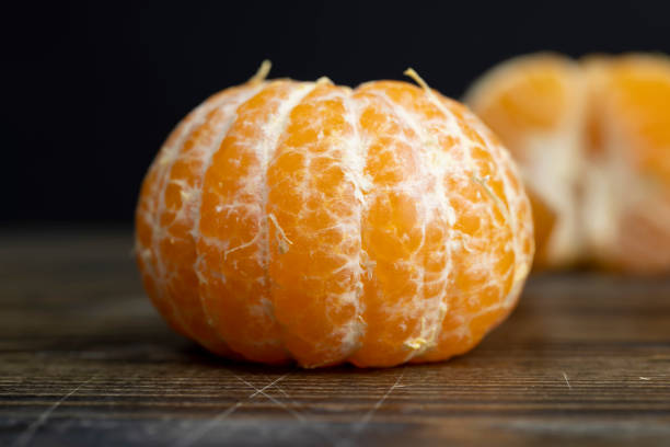 istock mandarin fruit without shell on a wooden blackboard 2164536010