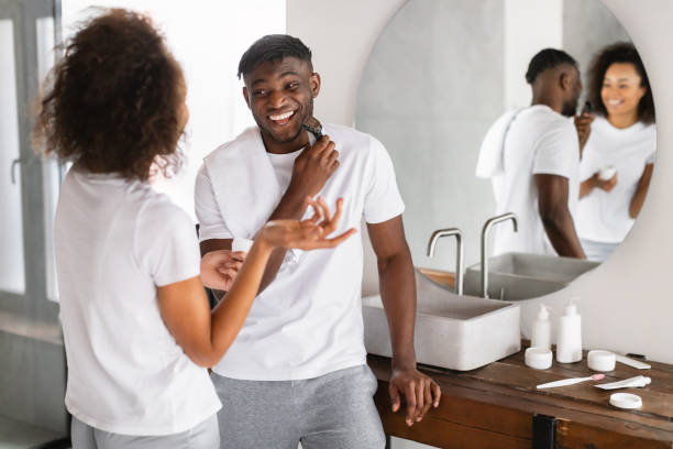 istock black couple talking and laughing while husband shaving in bathroom 2164536984