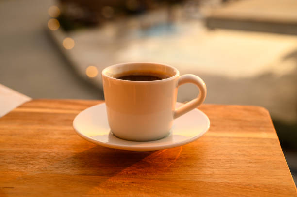 istock Cup of coffee next to a swimming pool 2164537788