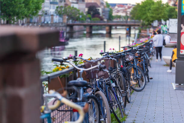 Strasbourg, France - May 13, 2024: Bicycles neatly lined up along the riverside in Strasbourg