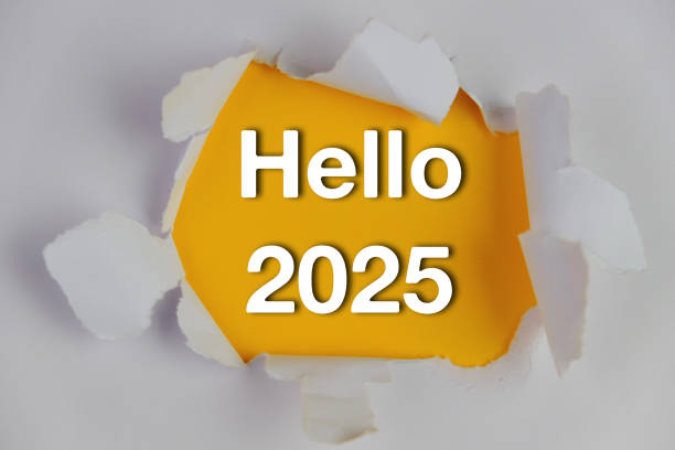 istock torn hole in white paper revealing an orange background. Text of HELLO 2025 2164553721