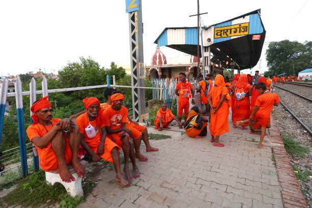 Indian Devotees known as 'Kanwariya' bath and take water from river Ganges during kanwar yatra (A religious procession ) to worship their diety Lord Shiva in the holy month of Shrawan of Hindu Calender in Prayagraj,India. During their procession they take holy water of river Ganges and offer it to Lord Shiva at the end of the procession.