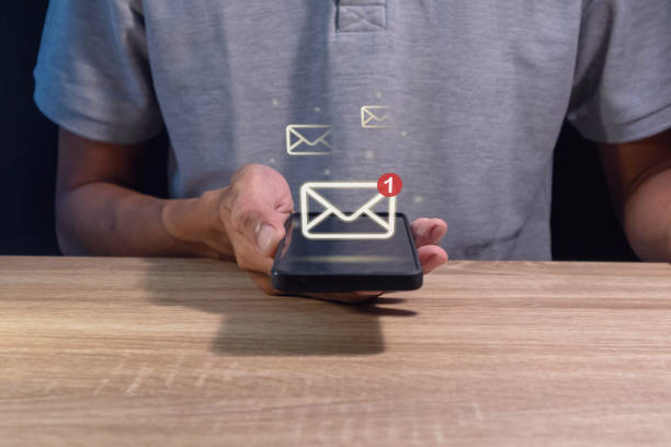 istock Man holding a mobile phone with email notification, new message or social media notification. 2164560432