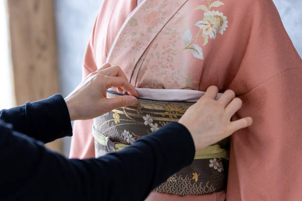 istock Dressing a woman in a kimono 2164564479