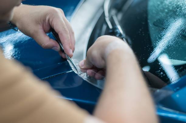 istock The master in the car service cuts the protective cutter. 2164567132