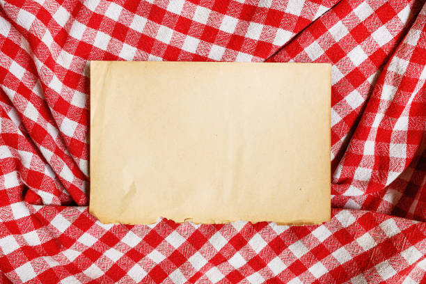Cooking recipe mockup, old yellow worn paper on checkered table cloth