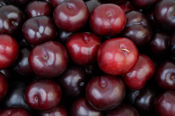 istock Ripe purple plums background 2164567591