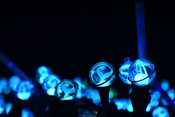 Glowing support stick and light sticks at a pop music concert.