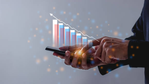 istock Young man using smartphone to visualize money growth The phone screen displays graphs and charts showing increasing investment and savings trends 2164570794