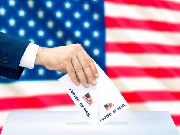 istock Voting by Mail in Front of American Flag 2164572330