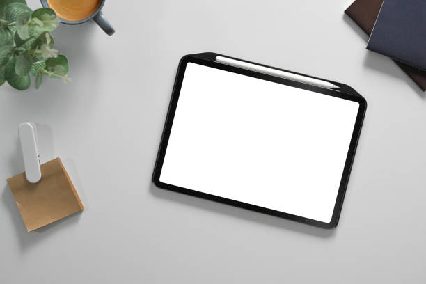 istock White office desk with digital tablet, cup of coffee and notepad. Flat lay, Top view 2164576126