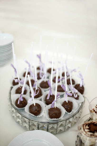 Sweet chocolate candies on a stick on a buffet table.