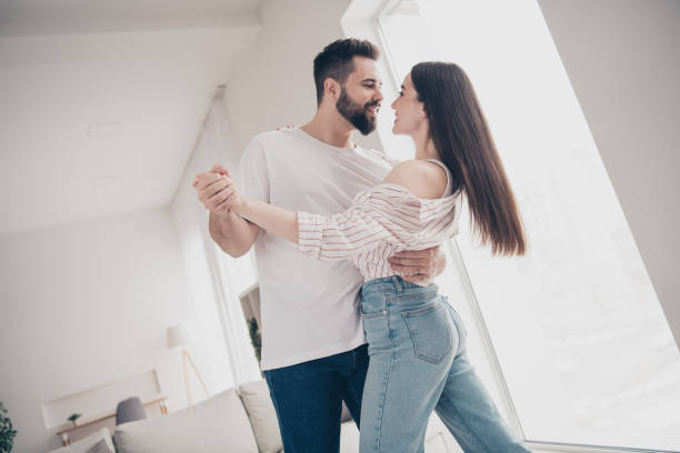 istock Photo of two idyllic partners cuddle dancing modern bright interior weekend flat indoors 2164580833