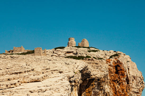 The rocky coastline of Kornati Islands in Croatia (Dalmatia) on a bright clear sunny summer day. Ruins on the cliffs of Mana Island