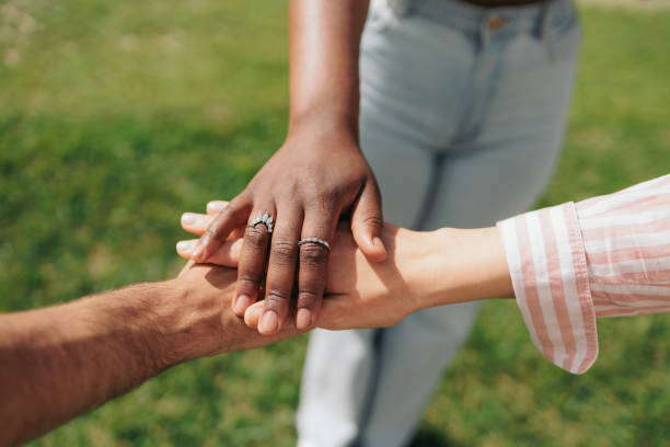 istock Multiethnic students putting their hands together. Teamwork, friendship, unity concepts. 2164583484