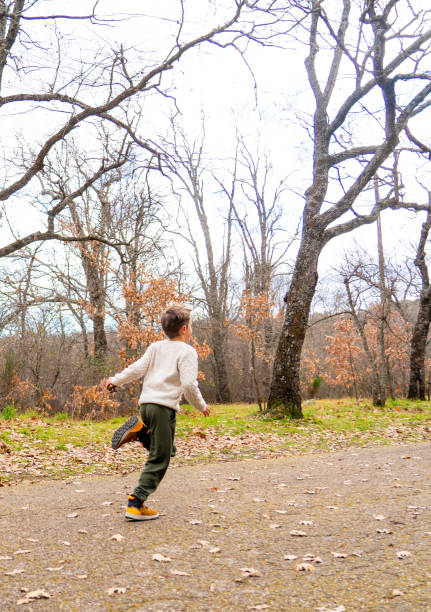 Boy running in a park in autumn