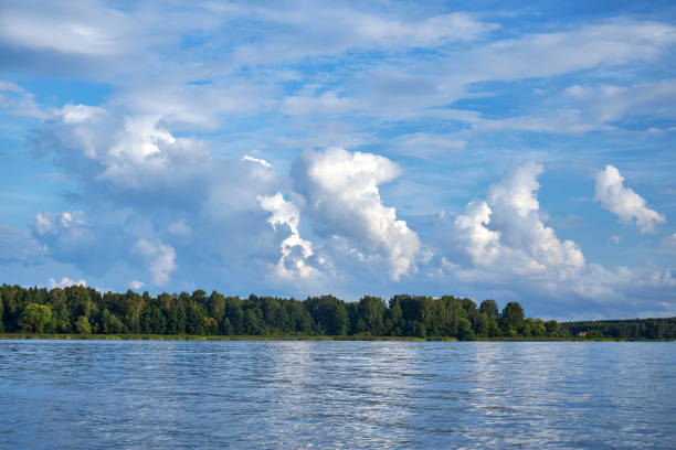 view from the boat on the river with waves and blue sky with white clouds