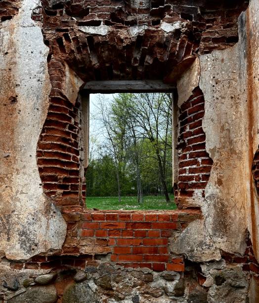 Window in an old abandoned building with brick walls
