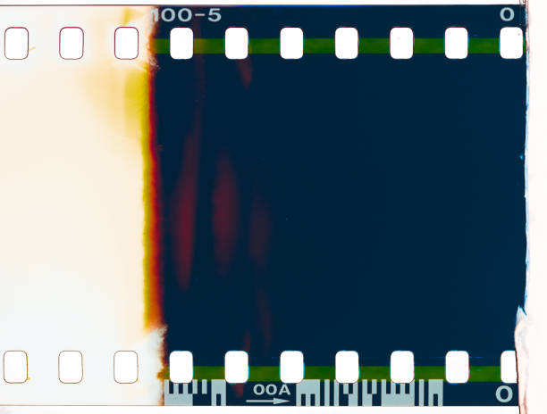 Close-up of the start of a roll of processed 35mm photographic transparency film, showing where the film has been exposed to light.