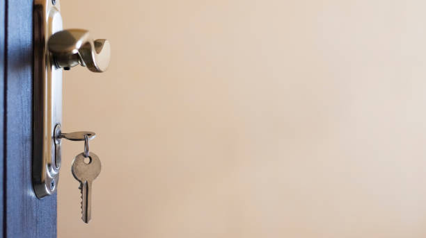 istock A Gleaming Key Hanging From A Door Handle In A Quiet Room 2164587167
