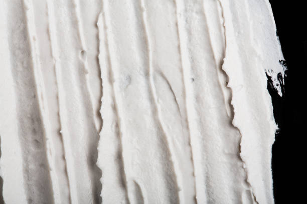 istock Structural plaster white on a black background. White Cream. paint smear. Plasticine 2164587378