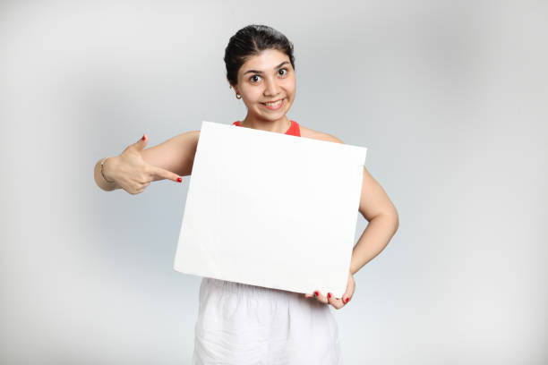 Handsome businessman holding a large poster for advertising signs