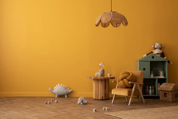 istock Minimalist composition of warm kid room interior with copy space, yellow wall, round stool, plush toys, green shelf, rattan lamp, bear rug, books and personal accessories. Home decor. Template. 2164590393