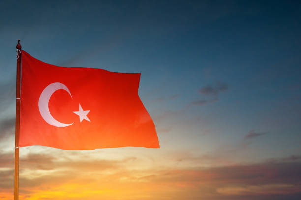 istock A Turkey flag with a star and crescent moon flying in the sky 2164591502