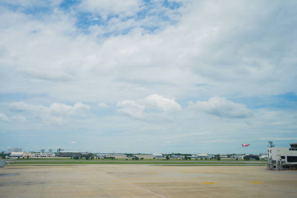 Aerial view of an airport runway with the direction marking 25 (250 degrees). A cockpit-like view during final approach and landing.