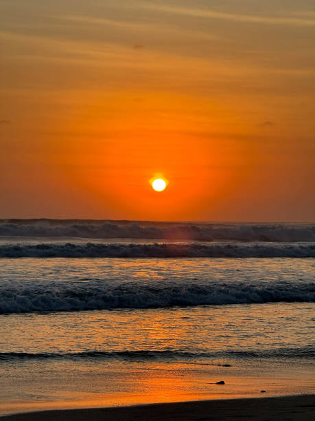 istock The sun is setting over the ocean, casting a warm glow on the water 2164594126