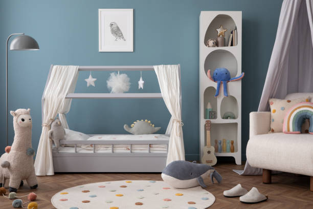 istock Creative composition of child room interior with mock up poster frame, cozy bed, stylish rack, blue wall, rack with toys, plush lama, gray lamp, guitar and personal accessories. Home decor. Template. 2164594698