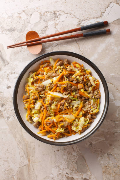 istock One Pot Egg Roll Bowl with beef, onion, carrot, cabbage closeup. Vertical top view 2164594748