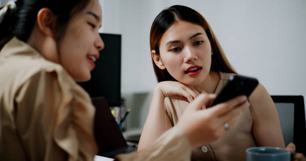 istock Two businesswomen are having a relaxing conversation after work. 2164594913