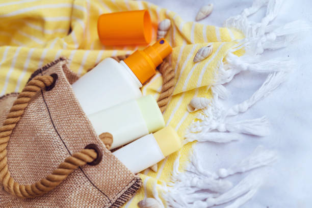 Sunscreen bottle with spf cream on background with shadows
